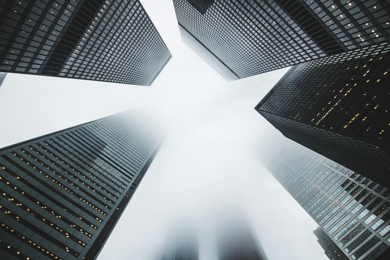 Upward view between tall commercial buildings
