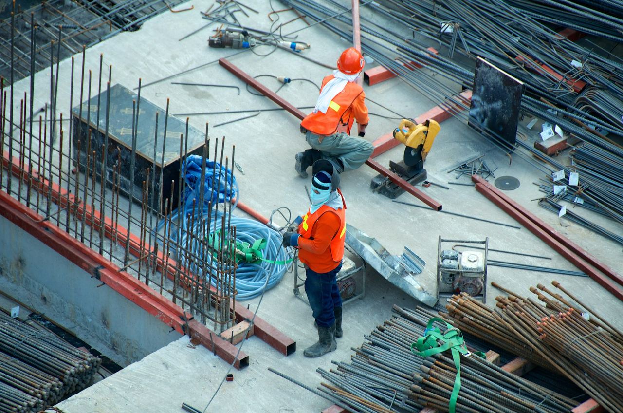 Construction crew working with steel reinforcement on site