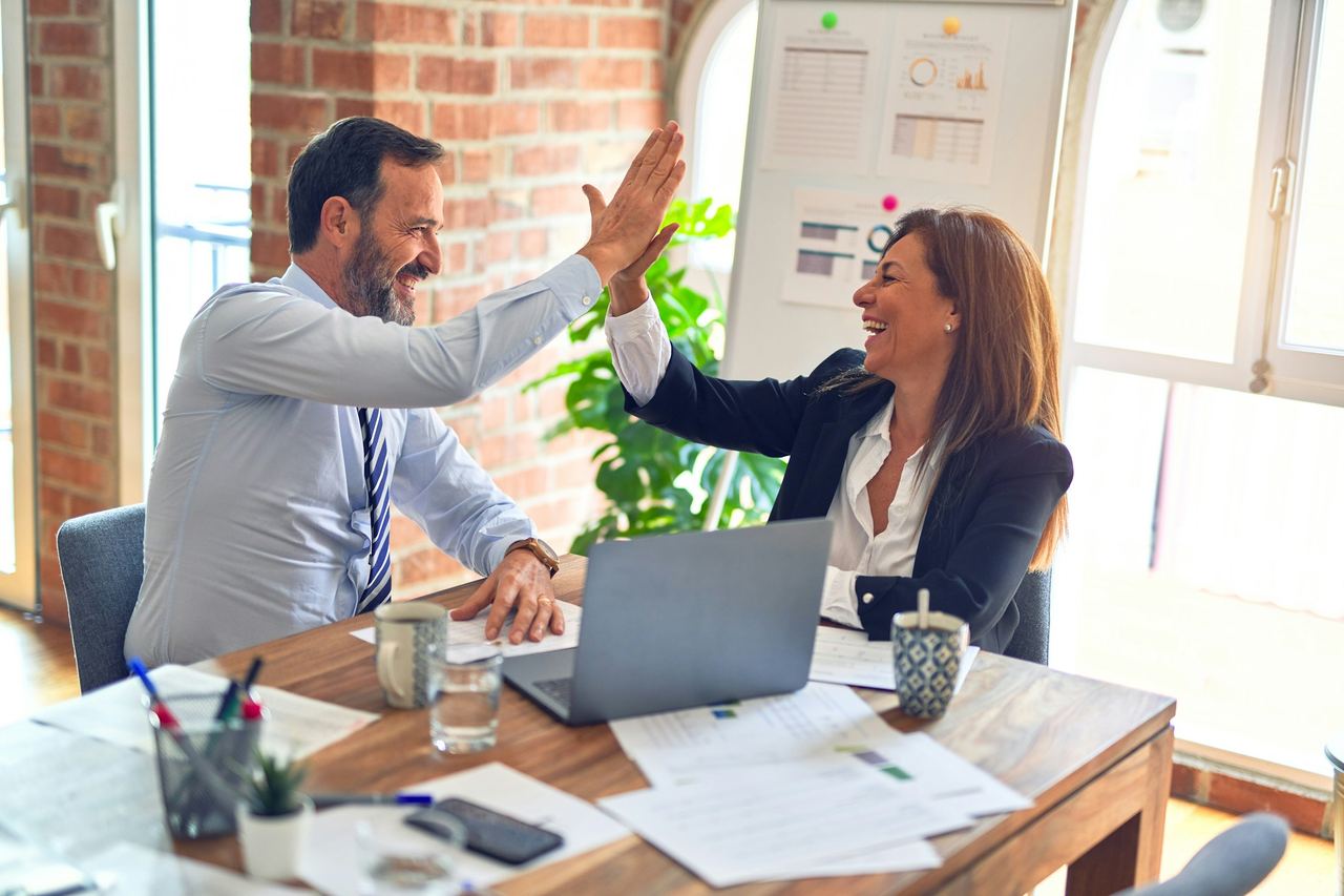 Two people meeting over project documents